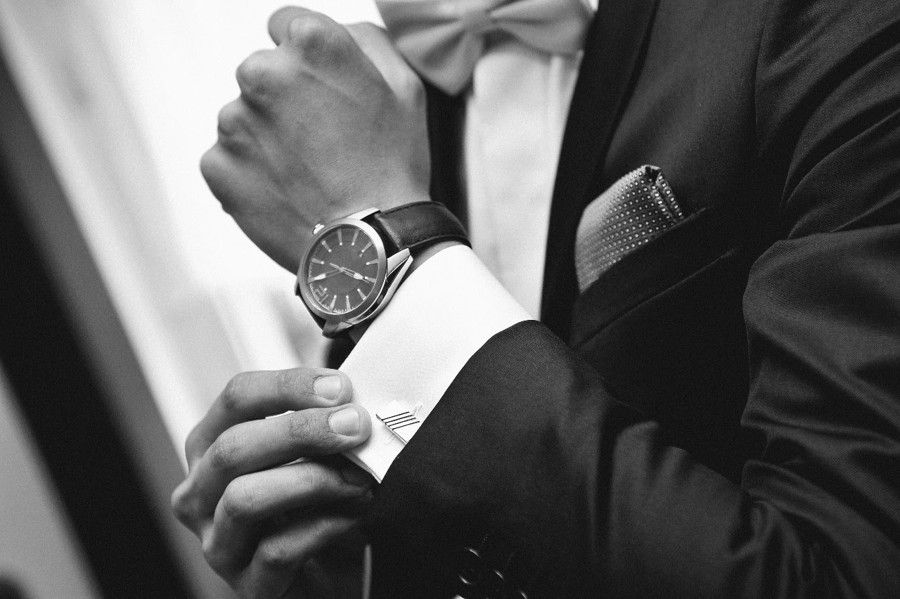 black and white photo of man with watch