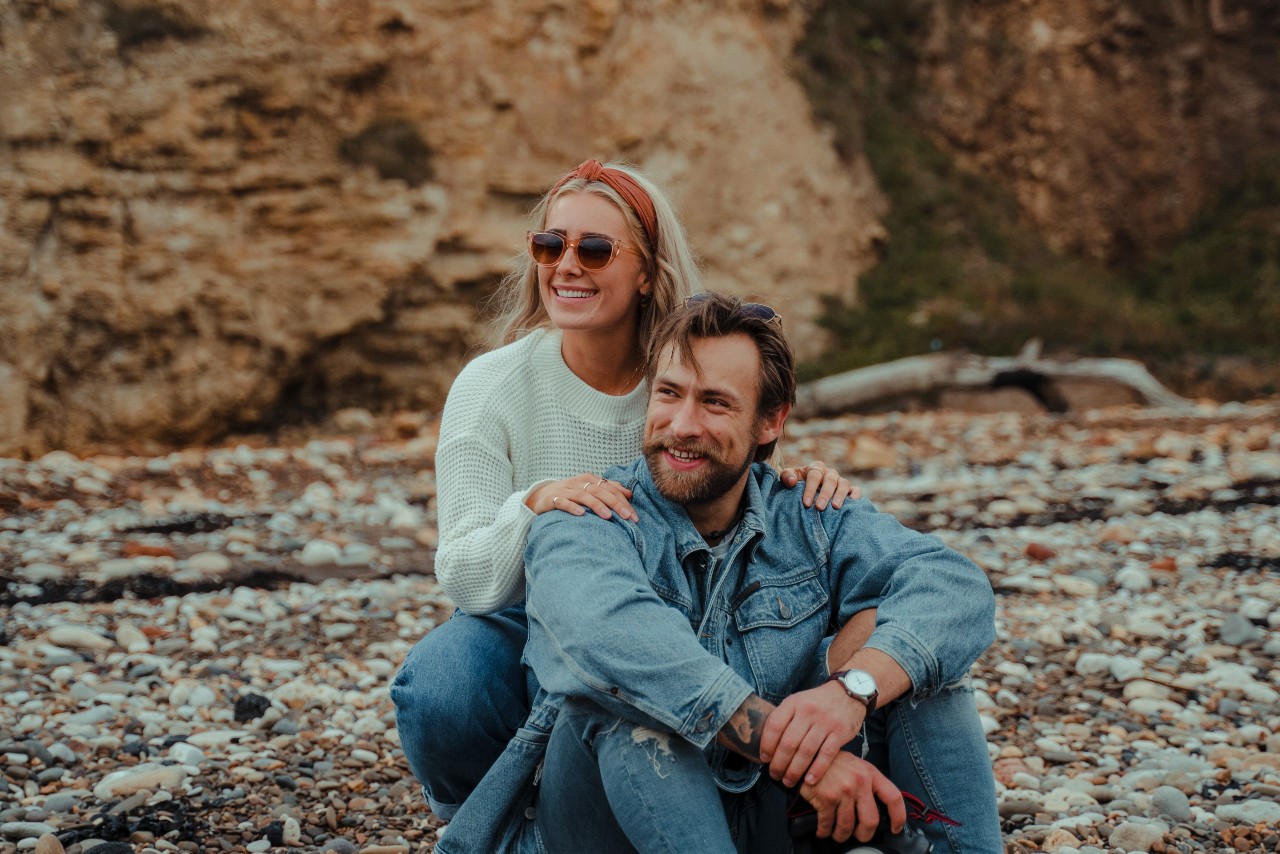 couple on rock with watches