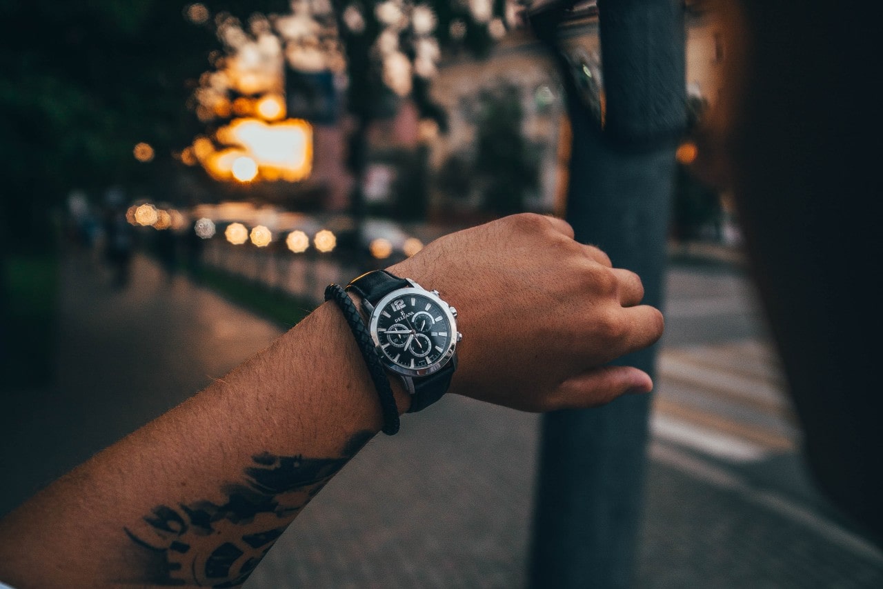 A man looking at his luxury watch