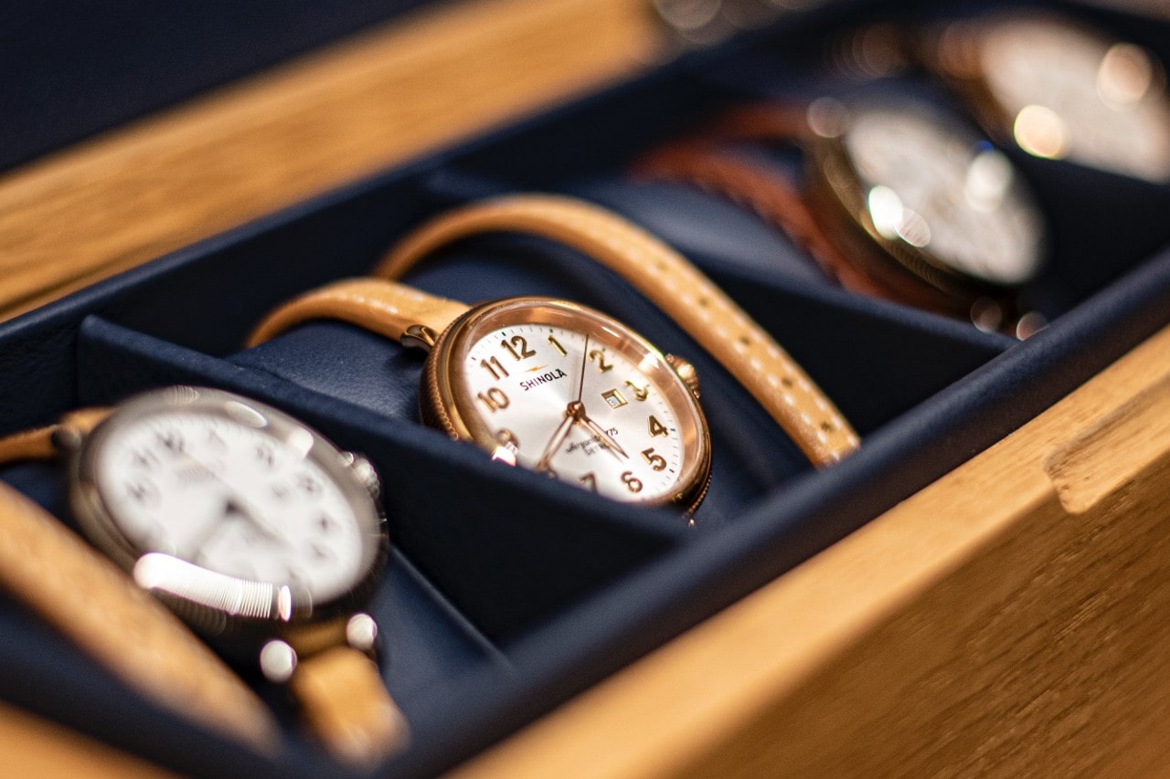 A selection of women’s fashion watches from Shinola are protectively displayed in a sales case at a retailer