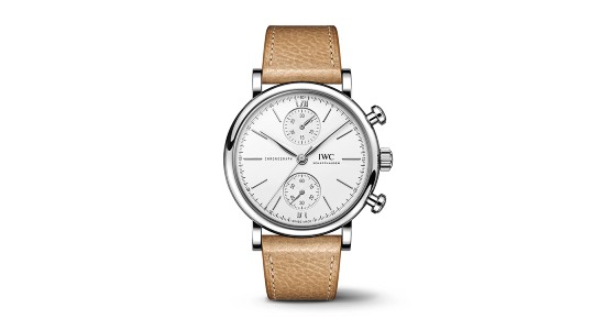 A silver IWC watch with a white watch face and two subdials as well as a tan leather strap