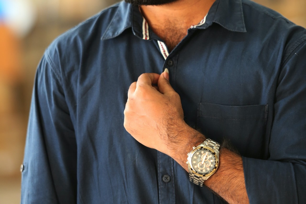 Man wearing a blue dress shirt and wearing a watch