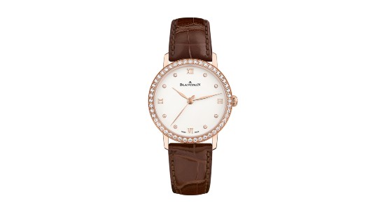 A Blancpain women’s watch with a red gold case, diamond bezel, and brown leather strap