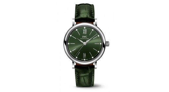 An IWC watch with silver case, green dial, and green leather strap