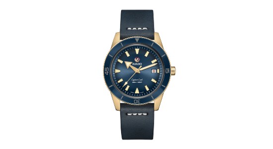 a navy blue and yellow gold watch by Rado