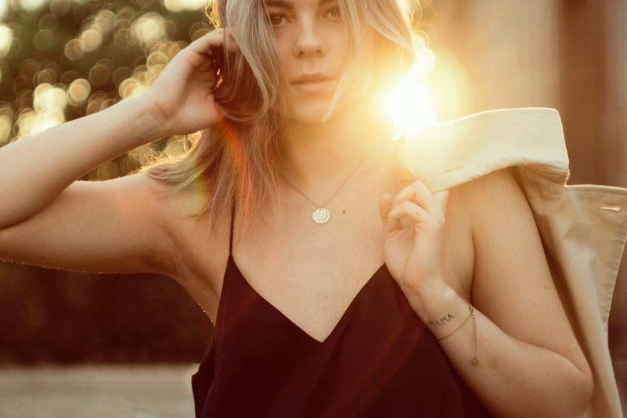 fashion necklace on woman in front of sunset