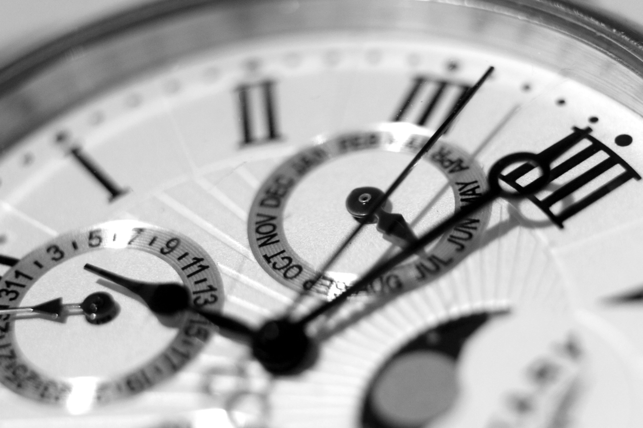 A close-up of a watch dial with month and day complications.