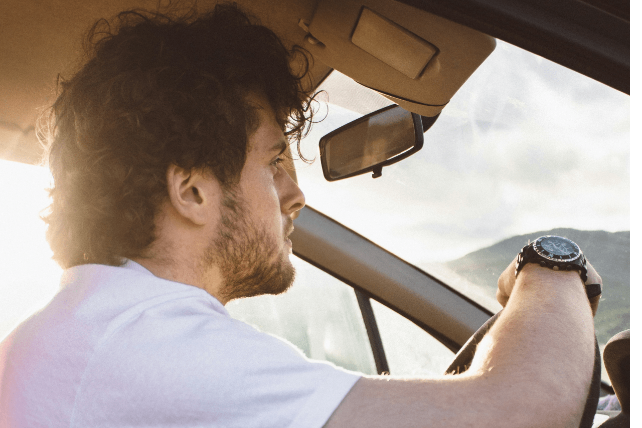 a man driving with a watch on his wrist