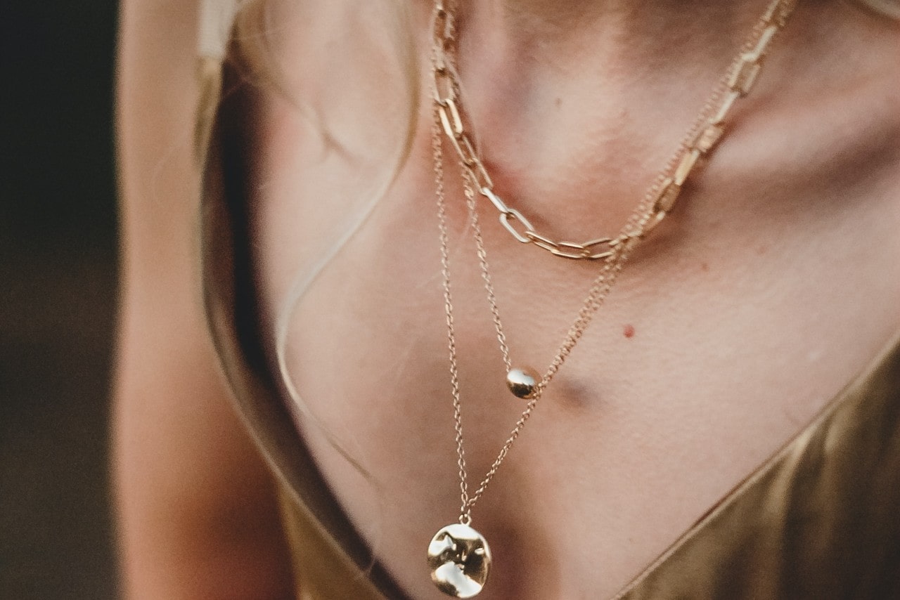 lady’s neckline wearing gold chain necklaces