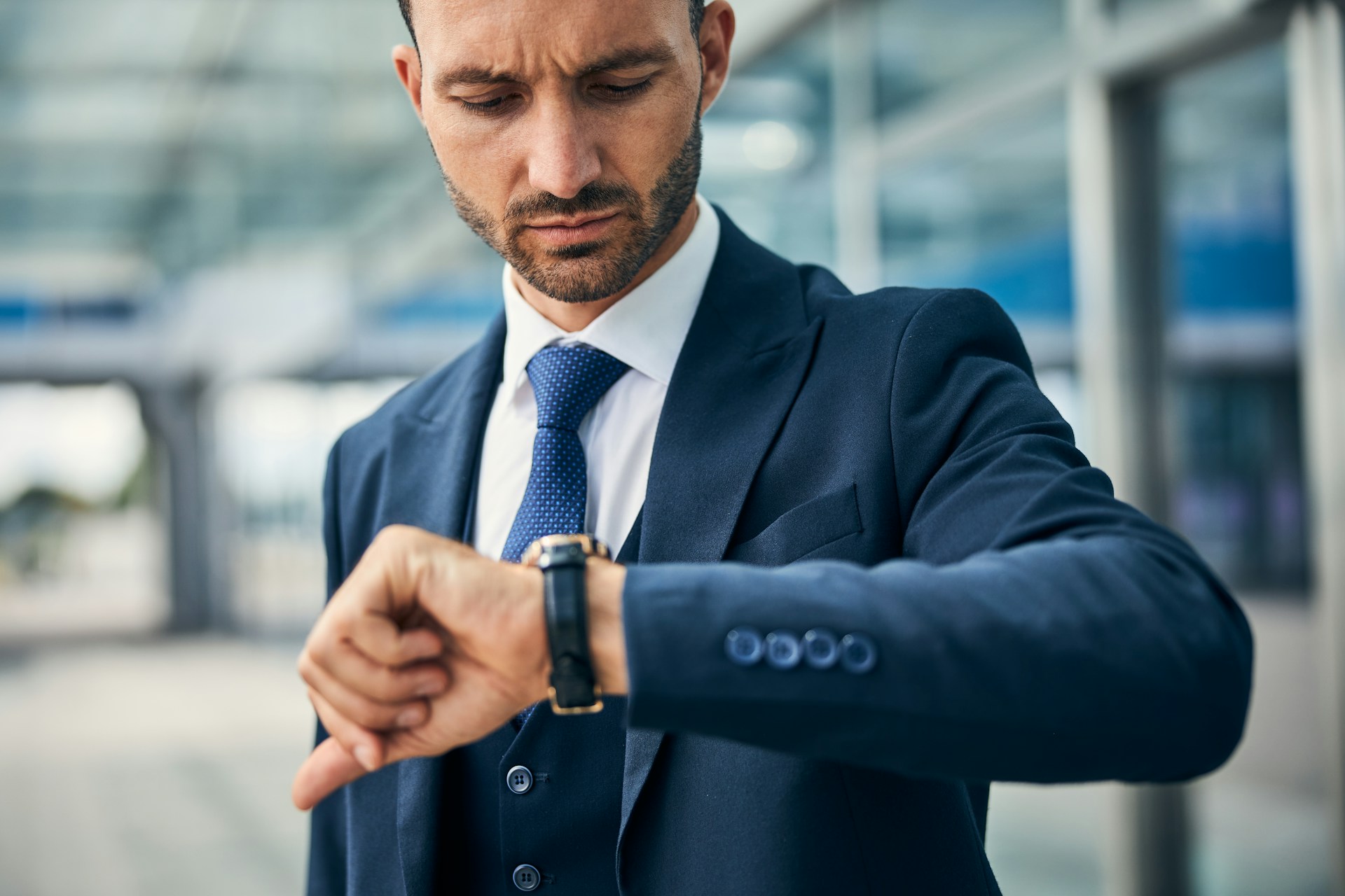 a man in a suit checking his watch