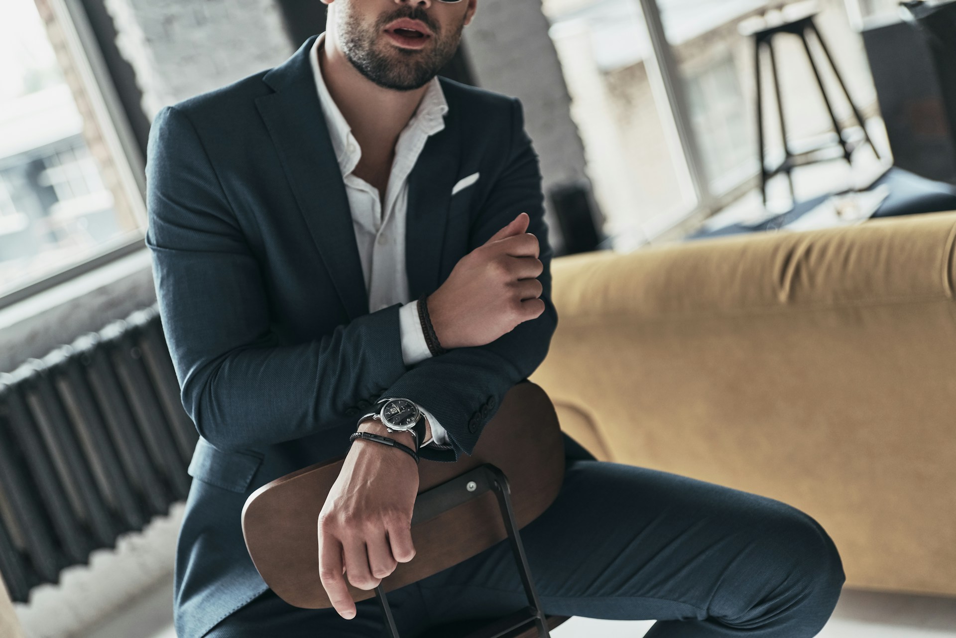 a man in a suit wearing a luxury watch